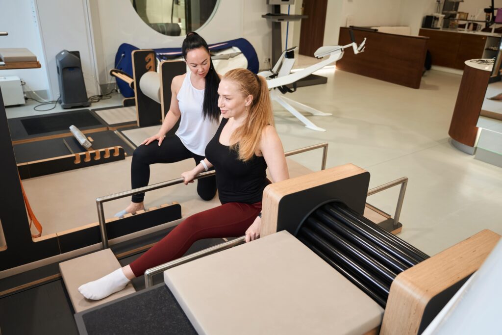 modern studio space with reformer pilates las vegas equipment and instructor coaching client