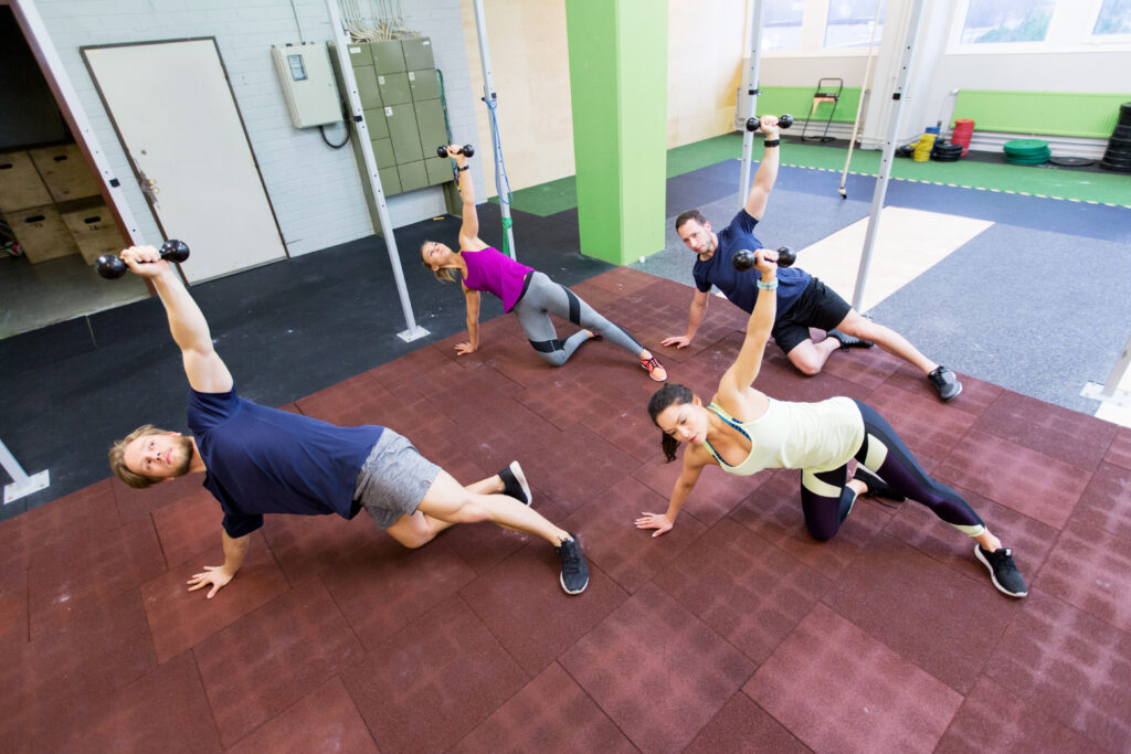 Instructor guiding a student through a gentle reformer stretch during a Sunday Pilates Las Vegas class.